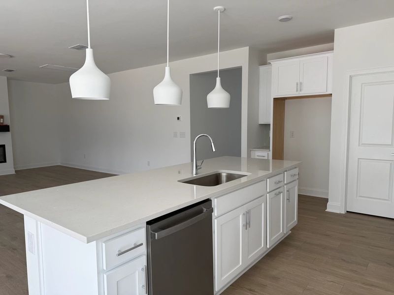 Kitchen featuring the AW Collection® Coastal - White cabinets and sea-glass tile backsplash. Kitchen featuring the AW Collection® Coastal - White cabinets and sea-glass tile backsplash.