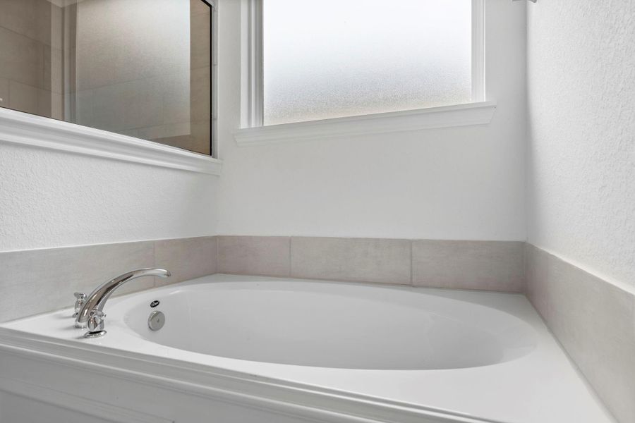 This additional view of your primary bathroom features tile flooring, fresh paint, walk-in shower, a separate garden tub, and a large walk-in closet. This additional view of your primary bathroom features tile flooring, fresh paint, walk-in shower, a separate garden tub, and a large walk-in closet.