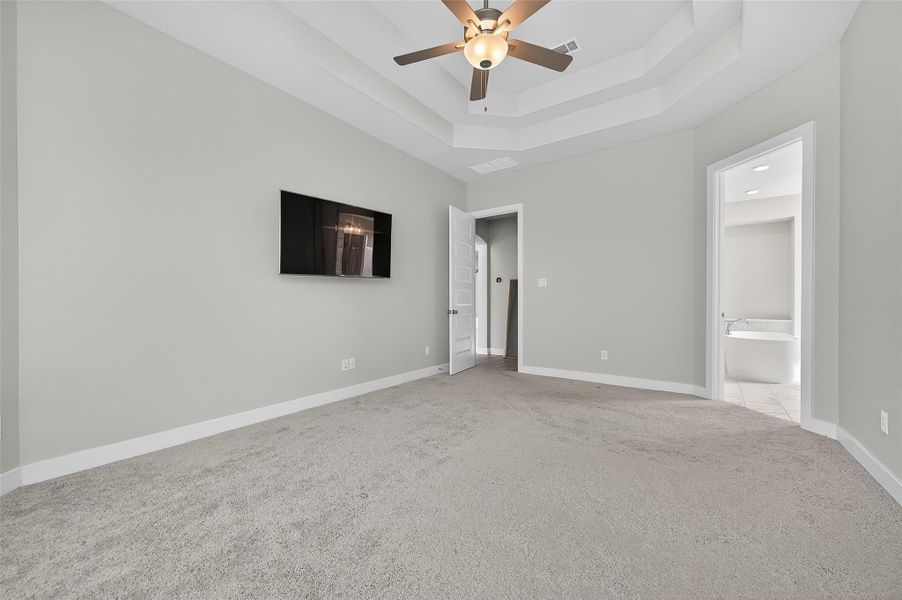 This primary suite also features a layout that includes direct access to the en-suite bath and a walk-in closet.