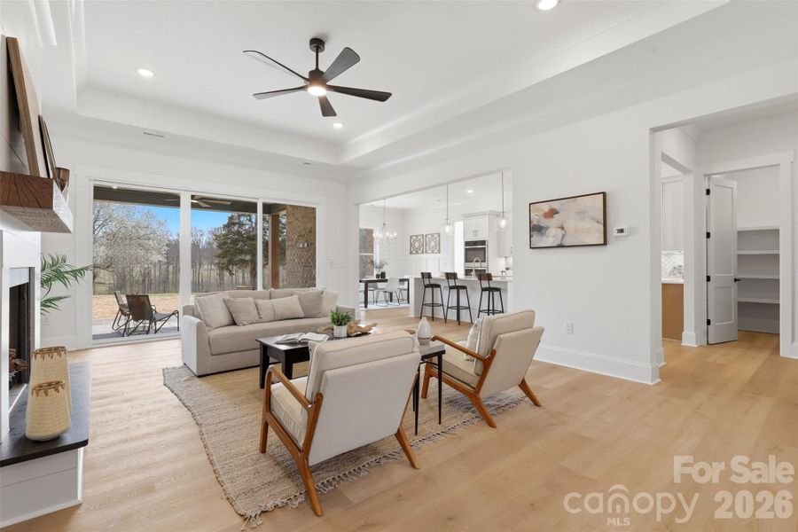 *representative photo- living room w/ tray ceiling, ventless gas fireplace, 8ft sliding glass doors to covered rear porch
