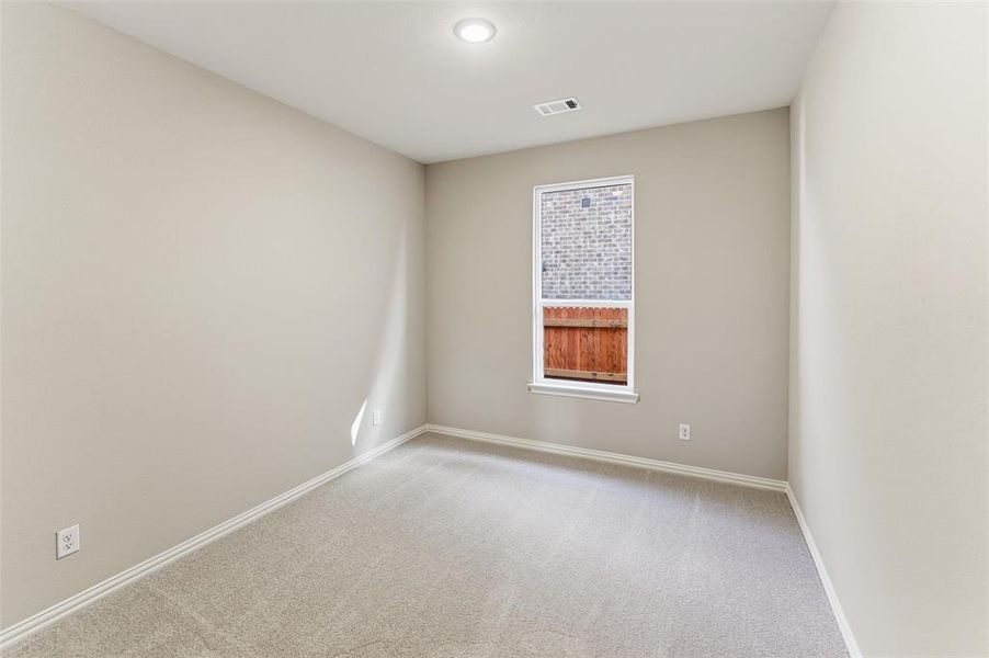 Carpeted empty room with baseboards