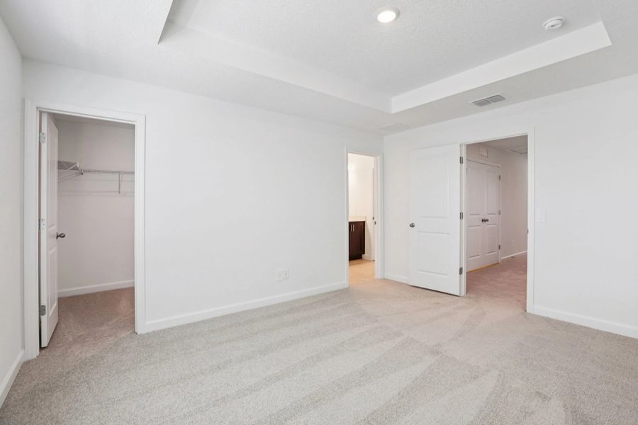 Primary suite provides a peaceful oasis with en suite bathroom and walk-in closet