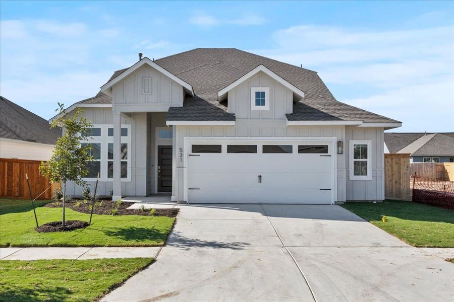 Front exterior of a new home in Trace, San Marcos, TX, highlighting curb appeal (Image 21).