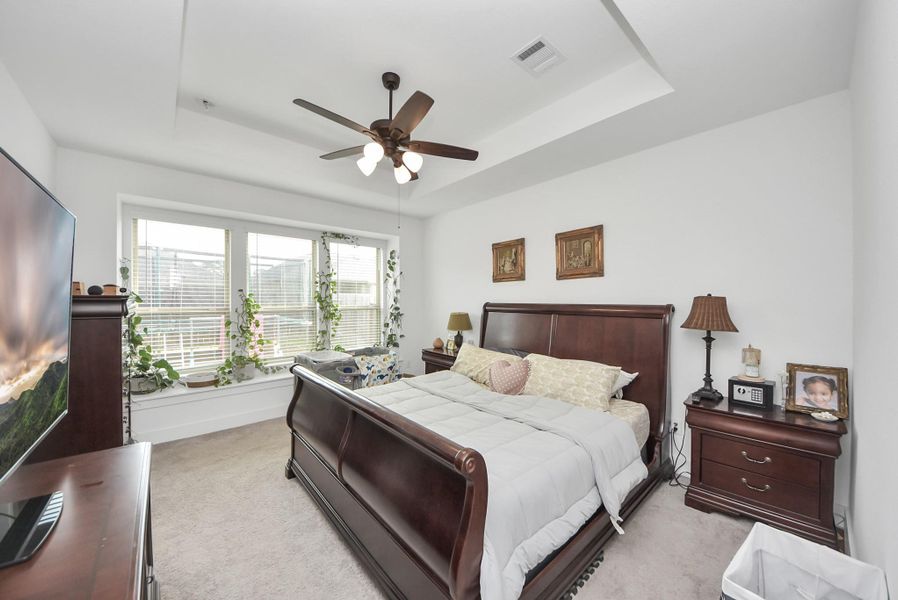 Spacious primary bedroom with great natural light and a warm, inviting layout.