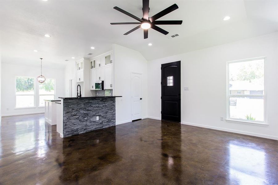 Living room with sink, ceiling fan, and vaulted ceiling