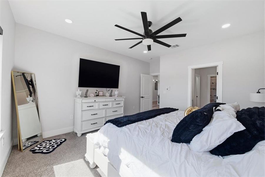 Bedroom featuring light carpet, ceiling fan, recessed lighting, and washer / clothes dryer