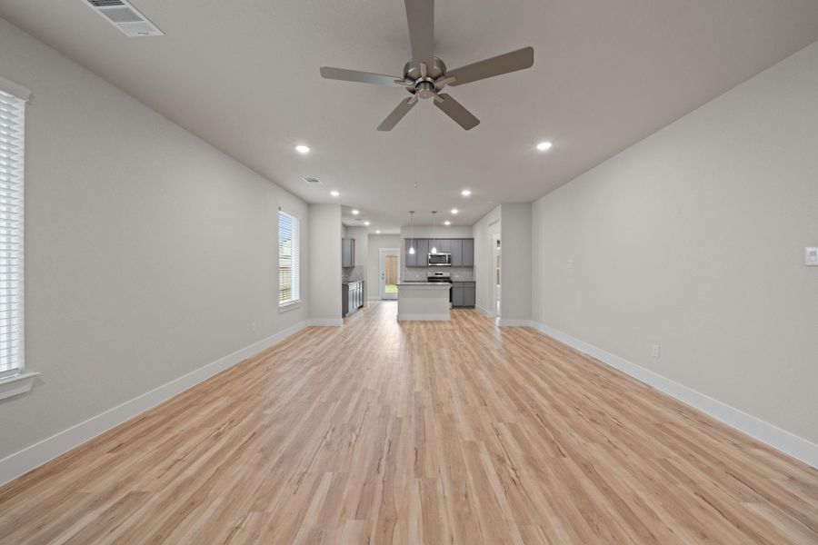 Flowing seamlessly into the kitchen and dining area, this living room is the heart of the home—ideal for family gatherings, movie nights, or simply enjoying your day-to-day in style.