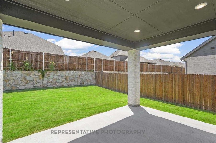 Fenced backyard featuring a patio