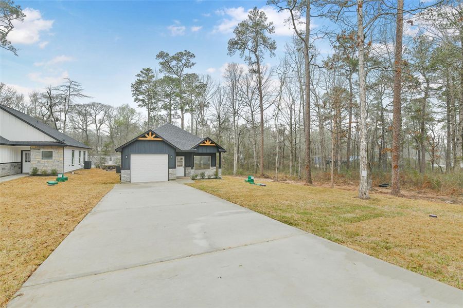 Front exterior of a new home in , Willis, TX, highlighting curb appeal (Image 24).