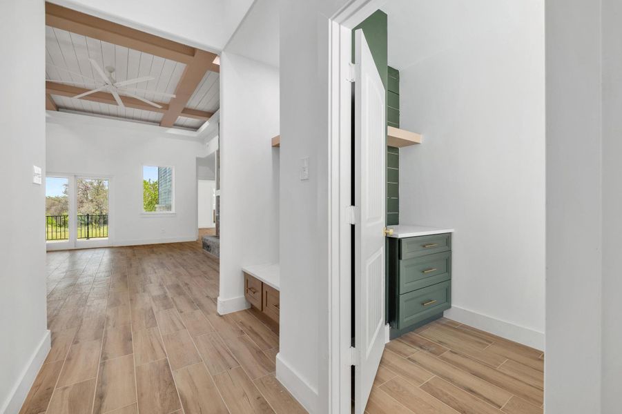 Hallway featuring wood tiled floors, coffered ceiling, and a wood ceiling with exposed beams Hallway featuring wood tiled floors, coffered ceiling, and a wood ceiling with exposed beams