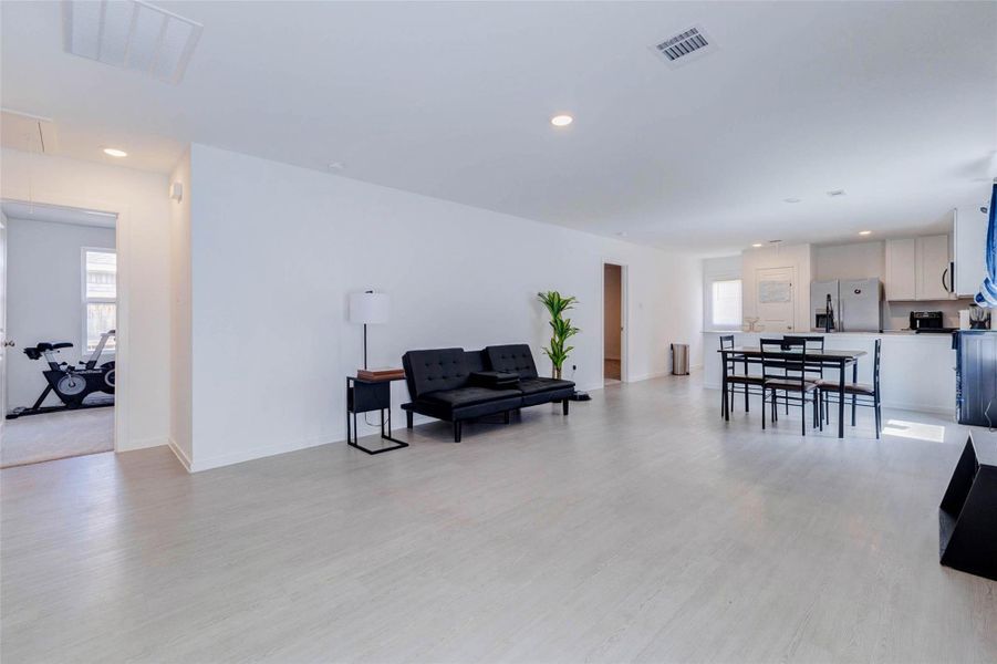 Spacious open-concept family room offering abundant natural light and seamless flow into the dining area and kitchen.