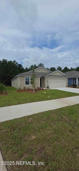 Front exterior of a new home in The Arbors, Jacksonville, FL, highlighting curb appeal (Image 30).