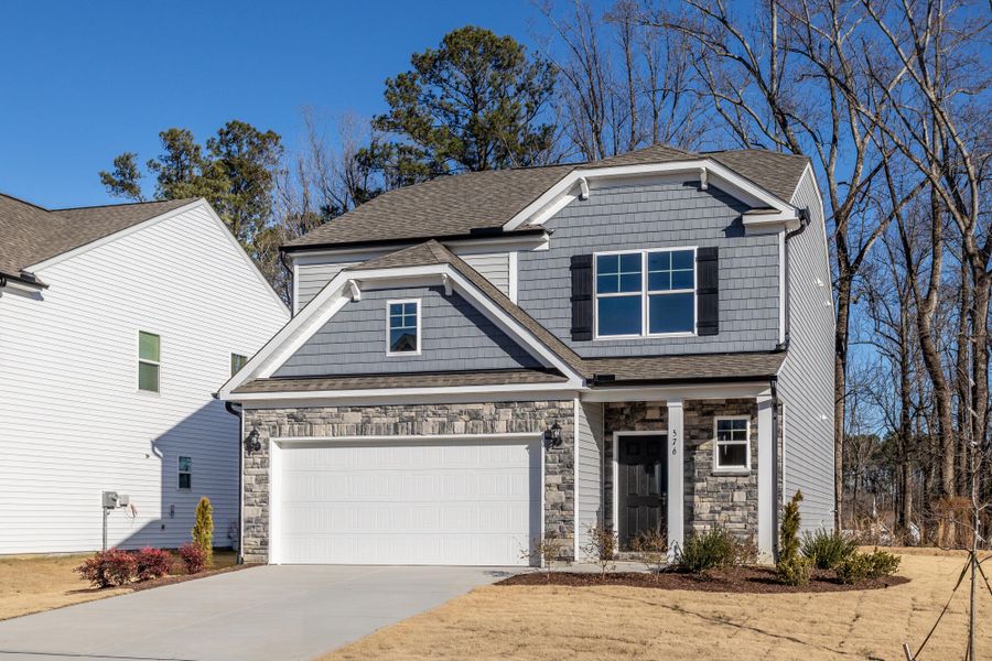 Front exterior of a new home in Daniel Farms, Benson, NC, highlighting curb appeal (Image 2). Front exterior of a new home in Daniel Farms, Benson, NC, highlighting curb appeal (Image 2).