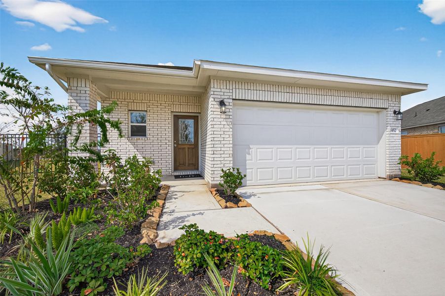 Front exterior of a new home in Sunterra, Katy, TX, highlighting curb appeal (Image 24).