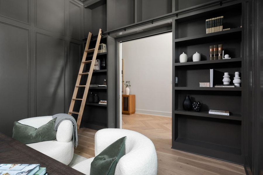 First floor study with built-ins, paneling, concealed closet, and library ladder.
