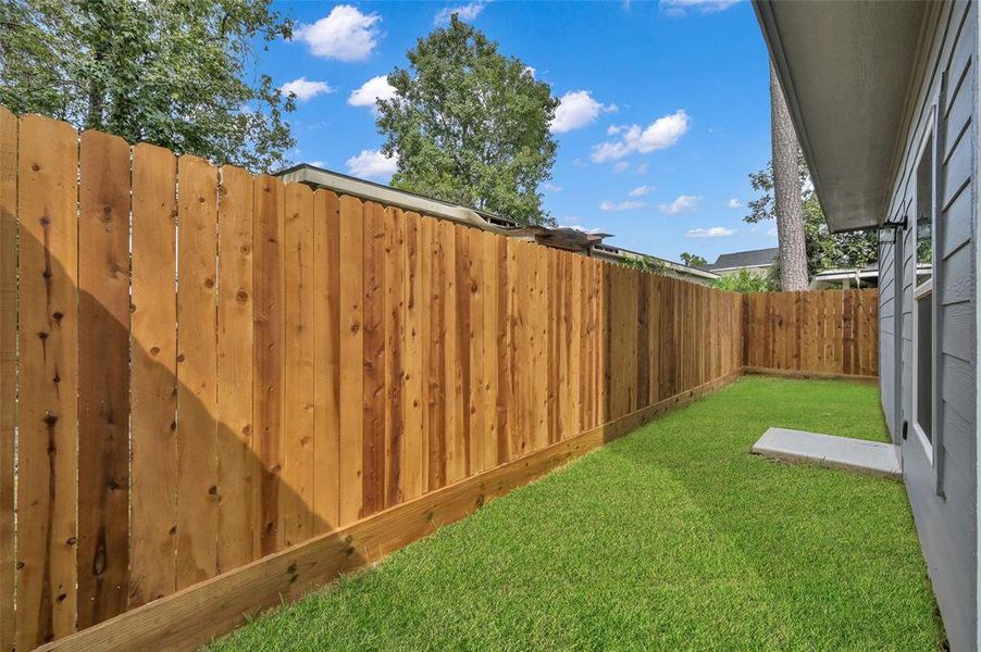 Enjoy serene privacy in your own lush backyard, encased by a brand-new 7ft wooden fence.