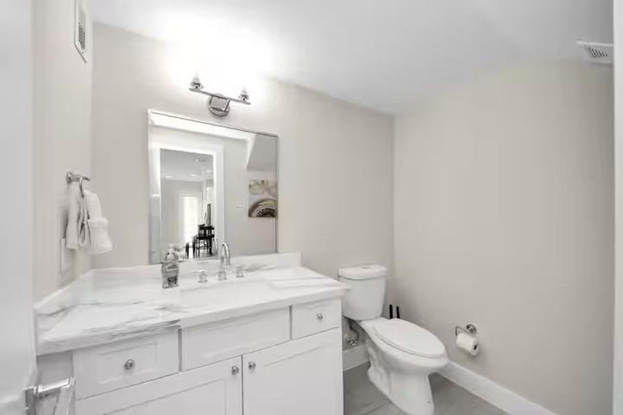 A conveniently located first-floor powder bath gives guests their own space without bringing traffic into the upstairs bedroom areas.
