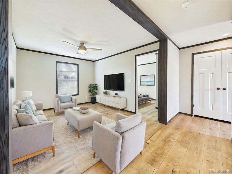 (Virtually Staged) – Staged Family space illustrating layout potential with comfortable seating arrangement and a bright, welcoming atmosphere.