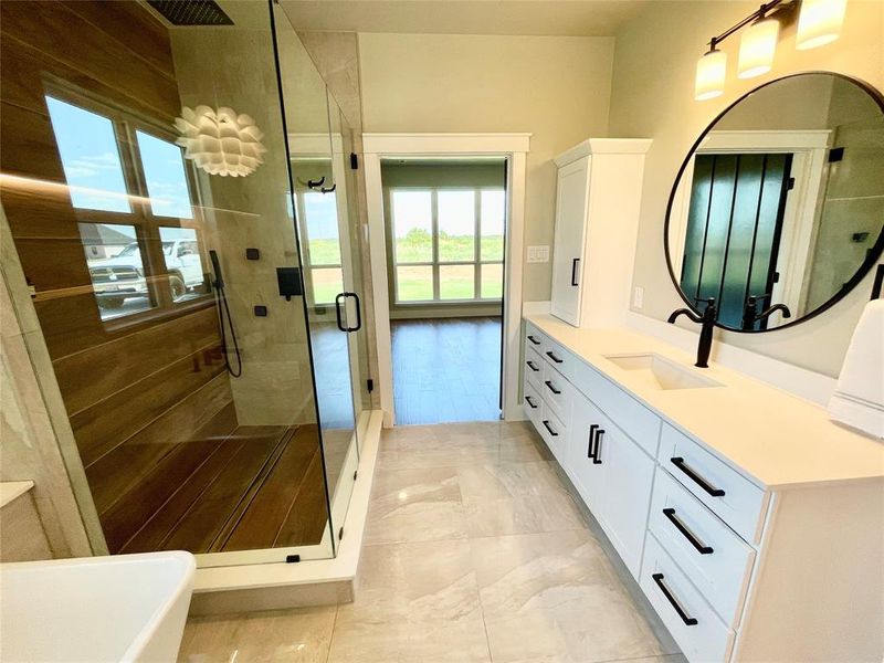 Bathroom with tile patterned flooring, shower with separate bathtub, and vanity