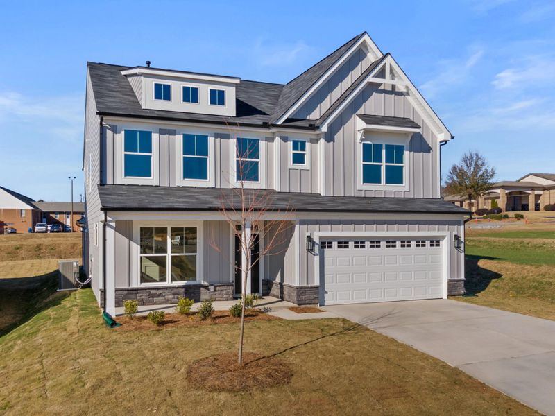 Front exterior of a new home in Founders Club, Moore, SC, highlighting curb appeal (Image 2). Front exterior of a new home in Founders Club, Moore, SC, highlighting curb appeal (Image 2).