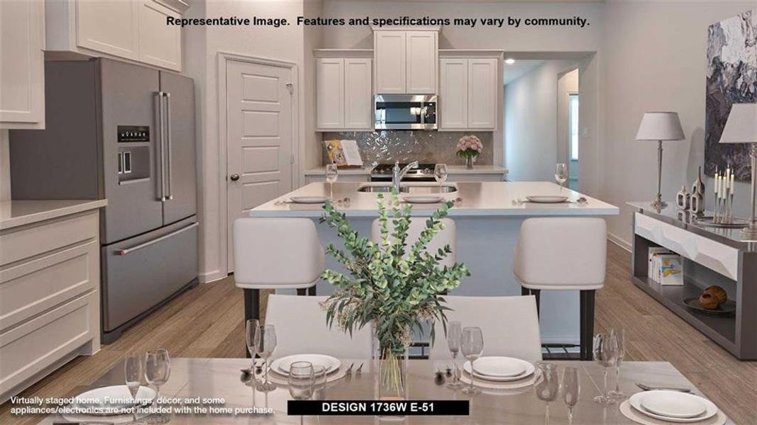 Kitchen with appliances with stainless steel finishes, light hardwood / wood-style flooring, white cabinets, and a center island with sink