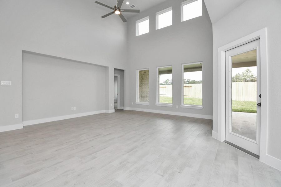 Welcome family and guests to your charming living room! With its high ceilings, recessed lighting, ceiling fan, custom paint, beautiful flooring, and large windows that let in abundant natural light, this room is perfect for gatherings. Sample photo of completed home with similar floor plan. Actual colors and selections may vary. Welcome family and guests to your charming living room! With its high ceilings, recessed lighting, ceiling fan, custom paint, beautiful flooring, and large windows that let in abundant natural light, this room is perfect for gatherings. Sample photo of completed home with similar floor plan. Actual colors and selections may vary.