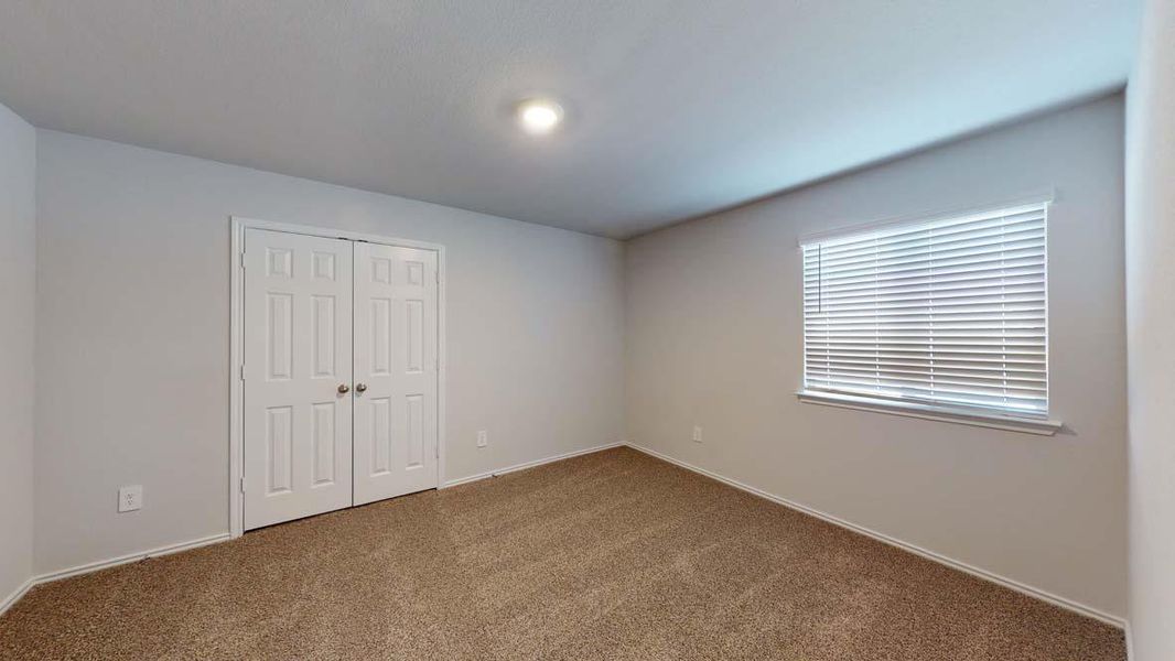 Unfurnished bedroom with a closet and carpet