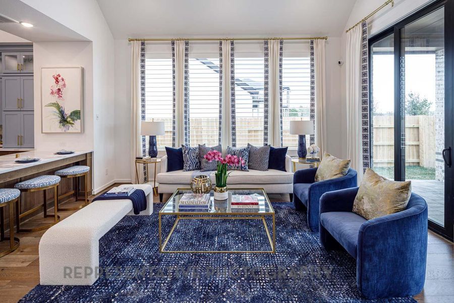 Living room with lofted ceiling and wood finished floors Living room with lofted ceiling and wood finished floors