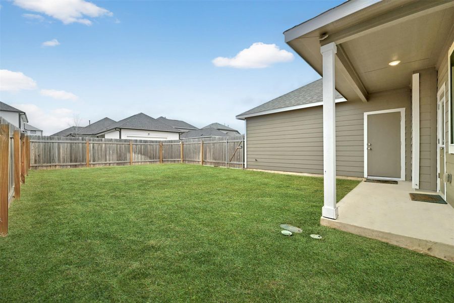 Fenced backyard featuring a patio Fenced backyard featuring a patio