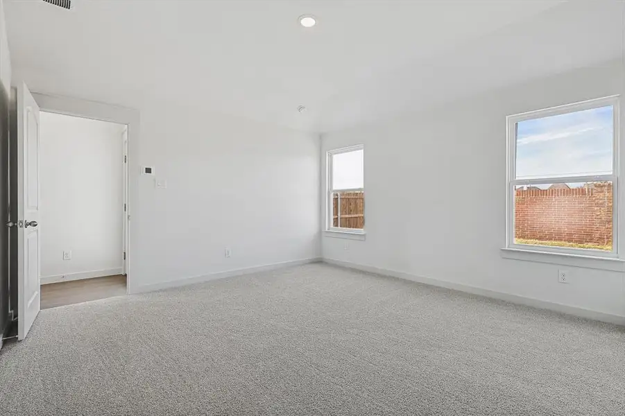 Empty room with light carpet and recessed lighting Empty room with light carpet and recessed lighting