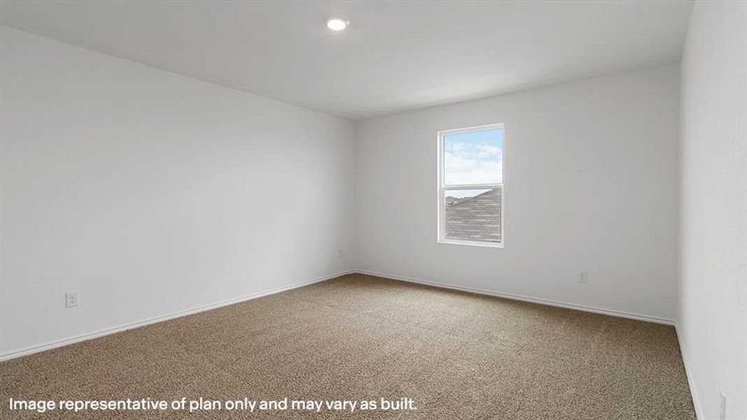 Carpeted spare room featuring baseboards