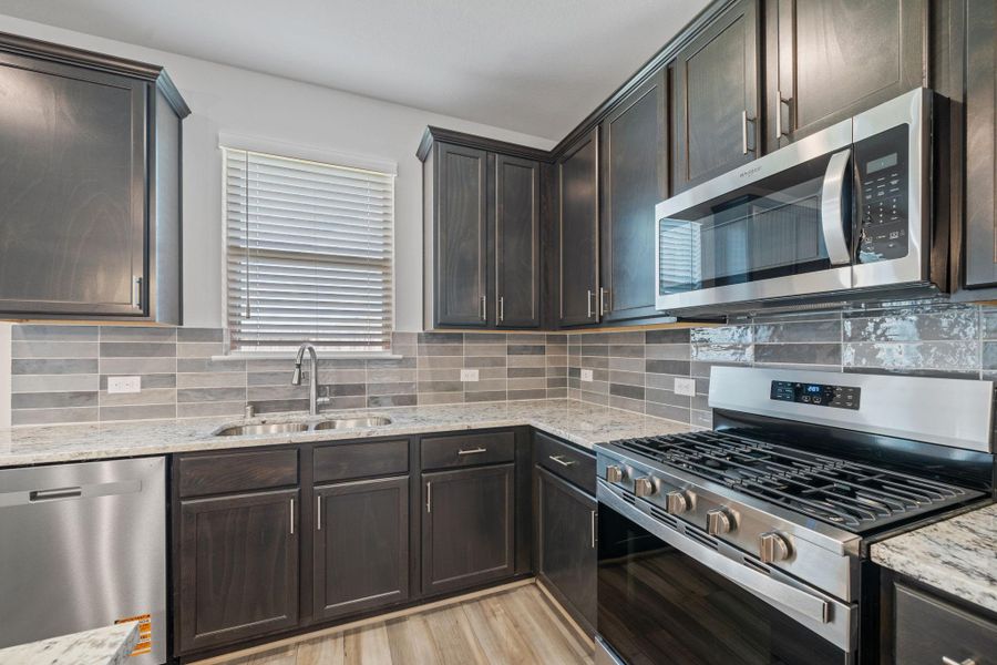 Every detail has been thoughtfully designed, from the state-of-the-art appliances that make meal prep a breeze, to the charming backsplash that adds a touch of personality. Every detail has been thoughtfully designed, from the state-of-the-art appliances that make meal prep a breeze, to the charming backsplash that adds a touch of personality.