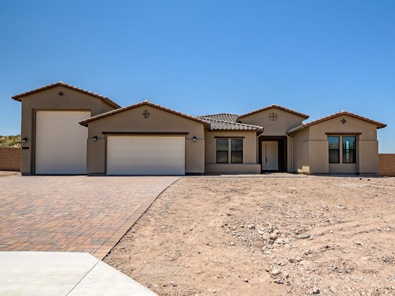 Front exterior of a new home in Estates at Kings Ranch, Gold Canyon, AZ, highlighting curb appeal (Image 1). Front exterior of a new home in Estates at Kings Ranch, Gold Canyon, AZ, highlighting curb appeal (Image 1).