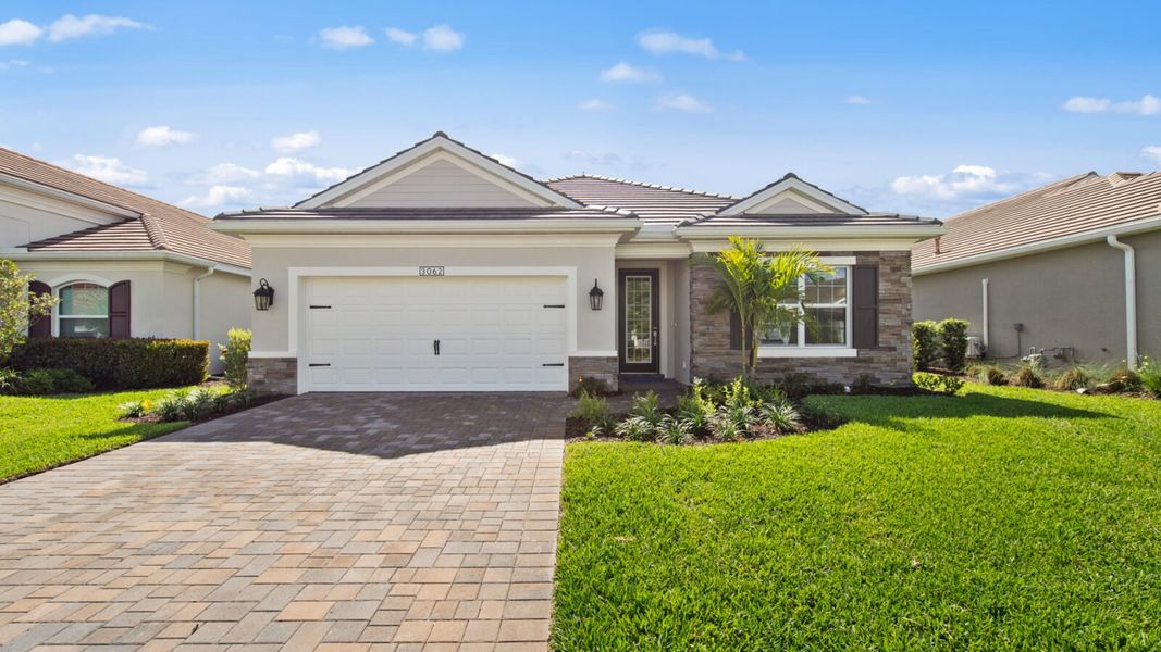 Front exterior of a new home in Verandah, Fort Myers, FL, highlighting curb appeal (Image 18).