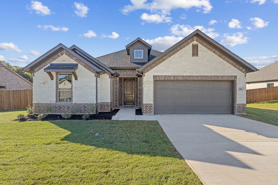 Front exterior of a new home in Fair Oaks, Bridgeport, TX, highlighting curb appeal (Image 1). Front exterior of a new home in Fair Oaks, Bridgeport, TX, highlighting curb appeal (Image 1).