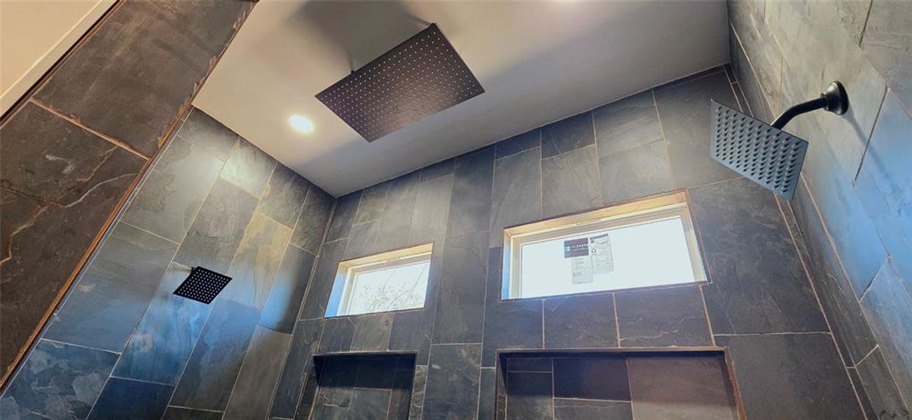 Bathroom view of stone shower with 3 shower heads Bathroom view of stone shower with 3 shower heads