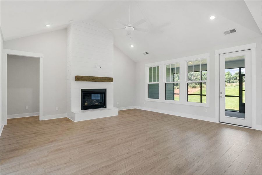 A spacious living area features high ceilings, a c A spacious living area features high ceilings, a c