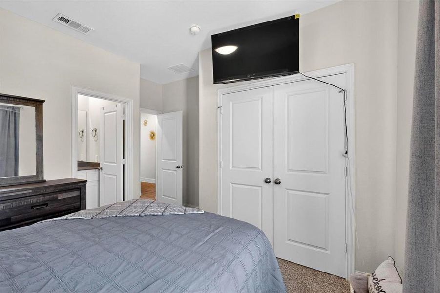 Carpeted bedroom with a closet Carpeted bedroom with a closet