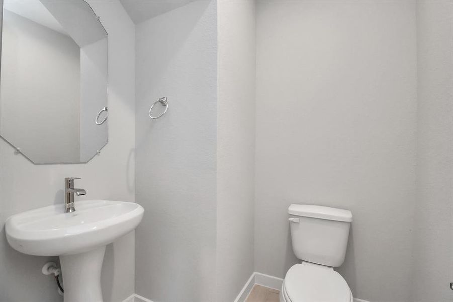 The half bathroom, conveniently situated on the 1st floor, is adorned with contemporary finishes.