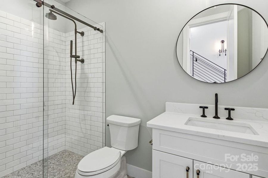 Beautifully appointed guest bath on main with modern finishes