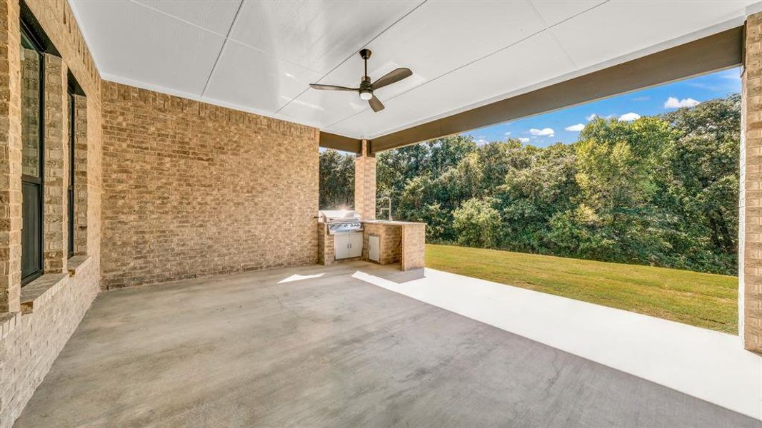 View of patio with a grill and ceiling fan