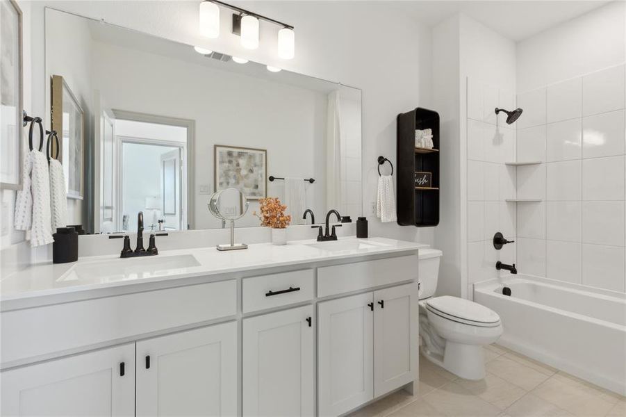 Guests will enjoy their own space in this thoughtfully designed, dual sink guest bath.