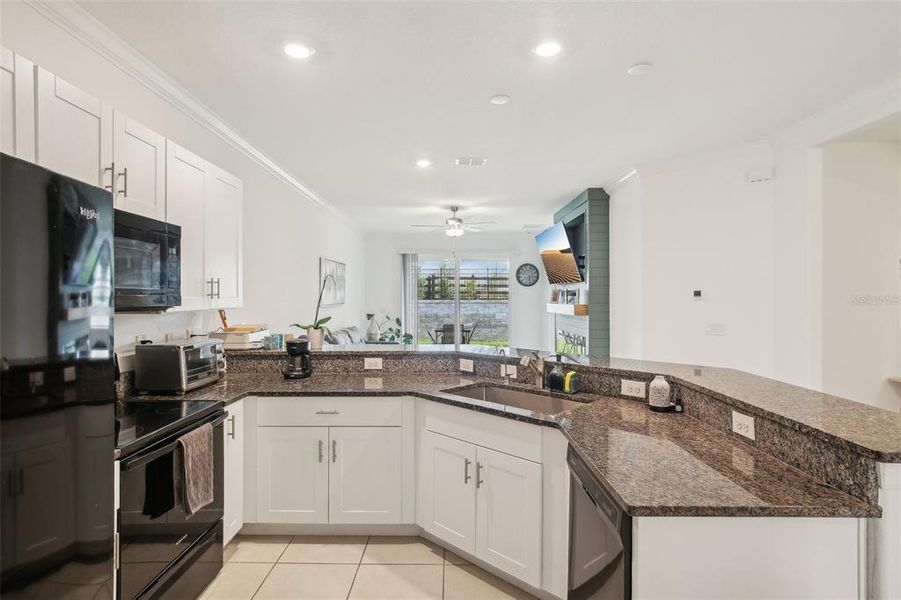 Kitchen with view into living area. Kitchen with view into living area.
