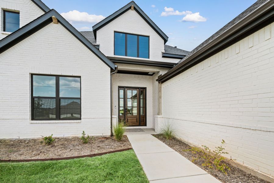 Front exterior of a new home in Highland Oaks, Boyd, TX, highlighting curb appeal (Image 23).