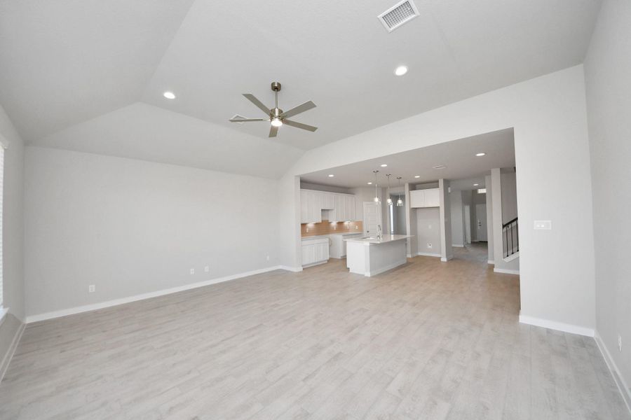 Family room flooded with natural light through the expansive windows. The premium tile flooring adds a touch of luxury to the space, creating the perfect setting for relaxing moments and cherished gatherings with loved ones. Sample photo of completed home with similar floor plan. Actual colors and selections may vary. Family room flooded with natural light through the expansive windows. The premium tile flooring adds a touch of luxury to the space, creating the perfect setting for relaxing moments and cherished gatherings with loved ones. Sample photo of completed home with similar floor plan. Actual colors and selections may vary.