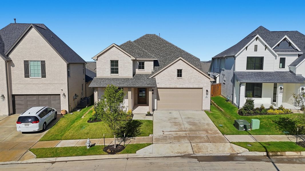 Front exterior of a new home in Tavolo Park, Fort Worth, TX, highlighting curb appeal (Image 2). Front exterior of a new home in Tavolo Park, Fort Worth, TX, highlighting curb appeal (Image 2).