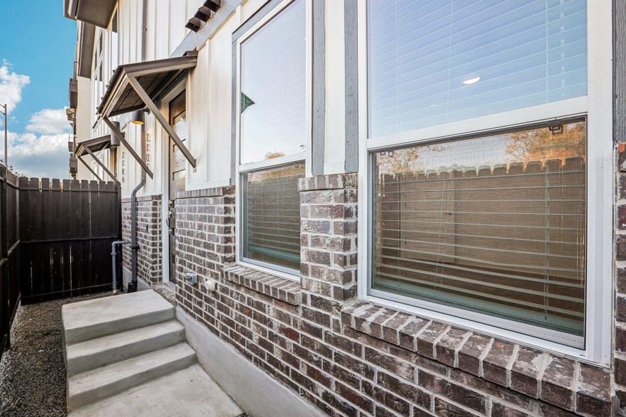 Exterior details and patio area of a home in Koenig Townhomes, Austin (Image 3).