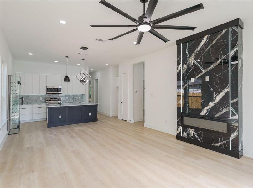 Unfurnished living room featuring a ceiling fan, light wood-style floors, and recessed lighting Unfurnished living room featuring a ceiling fan, light wood-style floors, and recessed lighting