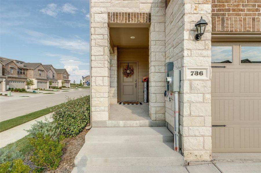 Doorway to property featuring stone siding and a residential view Doorway to property featuring stone siding and a residential view
