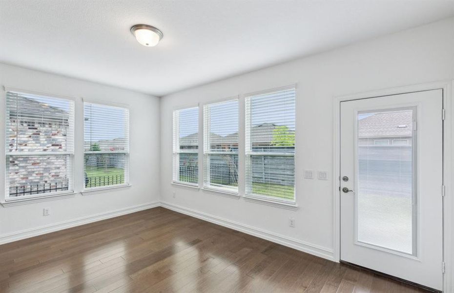 Spacious gathering room with large windows *real home pictured